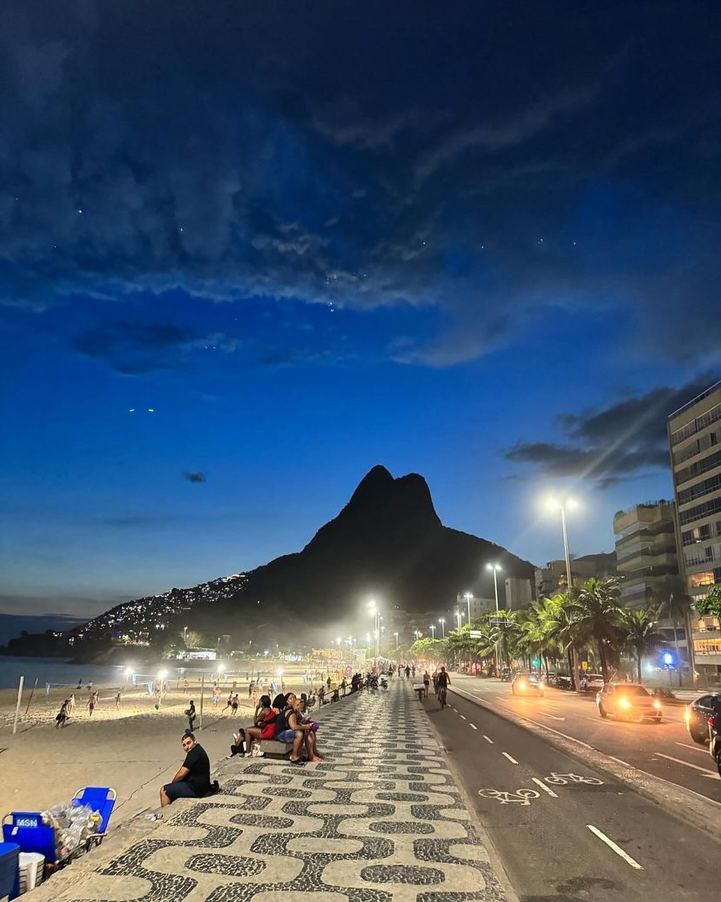 Executive transfer vehicle parked along Copacabana beach promenade in Rio de Janeiro following a door-to-door journey from Buzios.